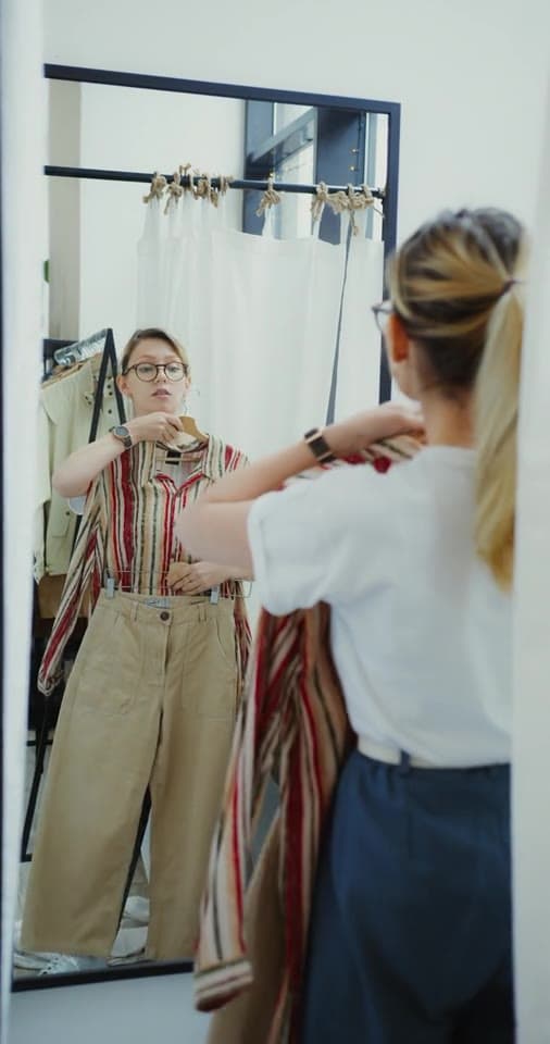 Example post: a creator trying on a striped top