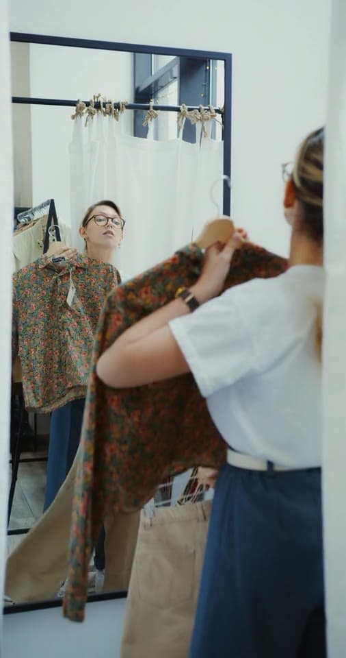 Example post: a creator trying on a patterned top